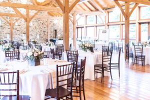Philadelphia wedding venue reception with beautiful windows, luxury farm tables and chiavari chairs