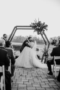 Philadelphia outdoor wedding ceremony with bride and groom kissing 