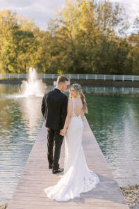 Philadelphia wedding venue with historic charm and waterfront outdoor wedding ceremony, bride & groom pose by the water for wedding day photography