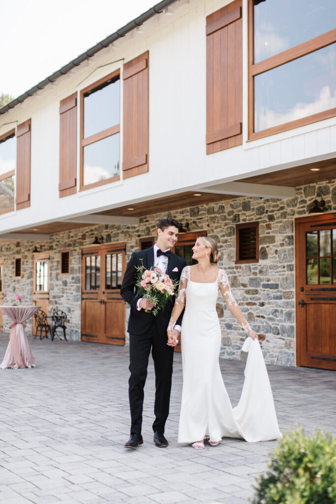couple standing in front of bluestone estate