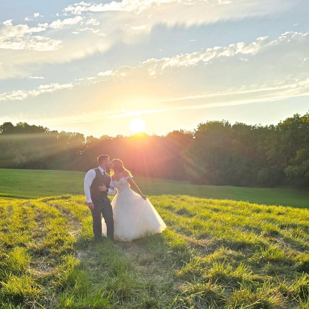 Bride and groom kissing during golden hour at a garden wedding venue near Philly, Wedding Venue Tour Checklist for Philly Couples