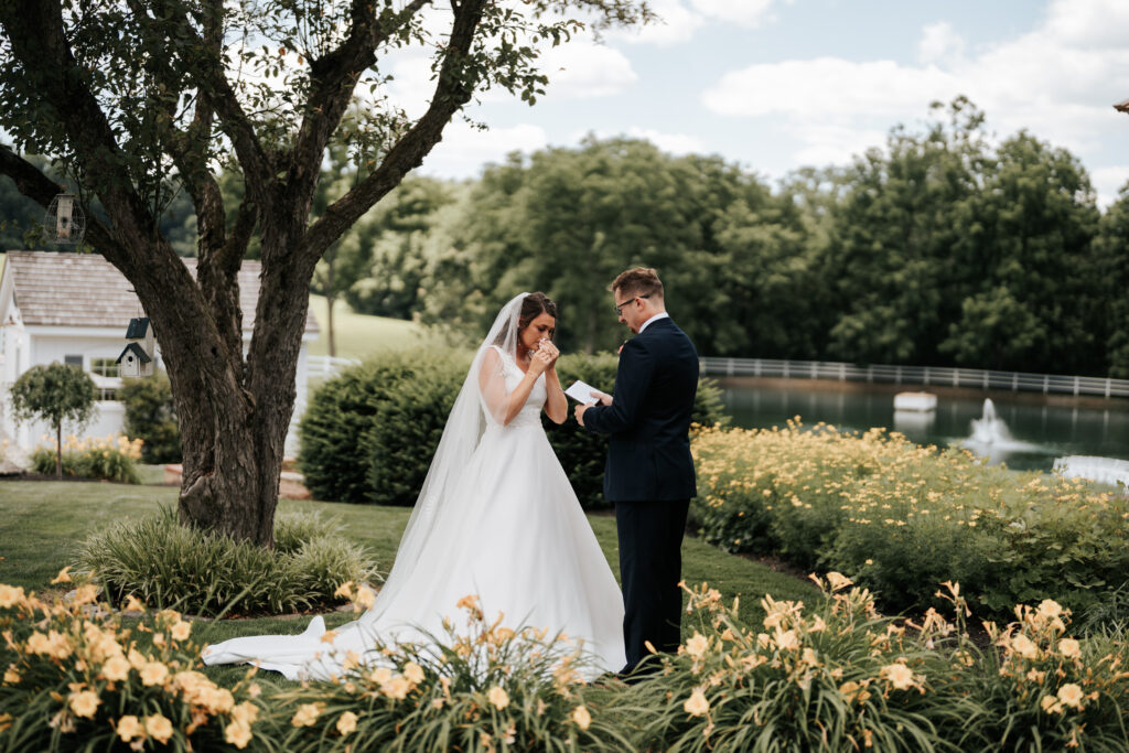 Philly bride and groom reading their vows at an outdoor garden wedding 