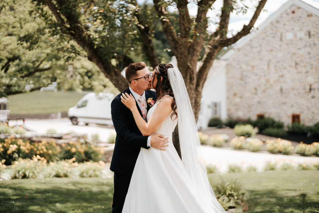 Bride and groom kissing at a garden wedding venue near Philly