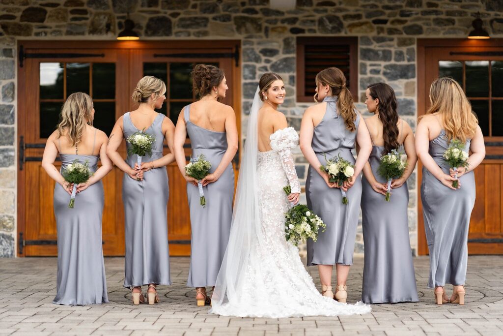 Bride and bridesmaids pose for wedding day photos at a historic wedding venue near Philadelphia